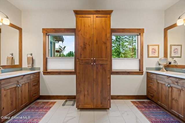 11667 N Eastshore Dr, Hayden, ID 83835 - bathroom with marble finish floors and two vanities