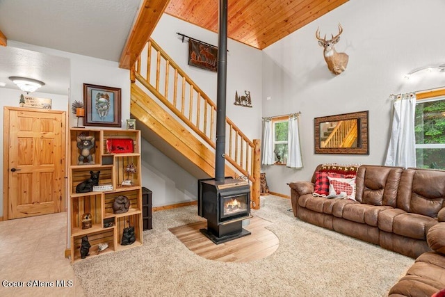 20264 Coeur Dalene River Rd, Kingston, ID 83839 - living area featuring a wood stove, stairs, vaulted ceiling, and wood ceiling