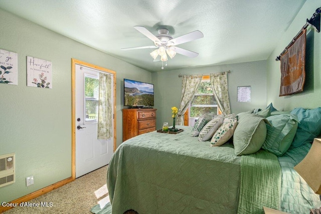 20264 Coeur Dalene River Rd, Kingston, ID 83839 - bedroom featuring multiple windows, light colored carpet, heating unit, and ceiling fan