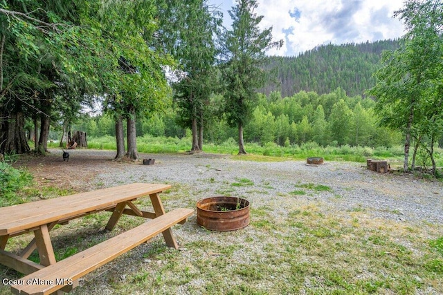 20264 Coeur Dalene River Rd, Kingston, ID 83839 - view of yard with an outdoor fire pit and a wooded view