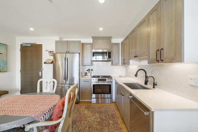 201 N 1st St # 1006, Coeur Dalene, ID 83814 - kitchen featuring stainless steel appliances, light countertops, light wood-style floors, and recessed lighting