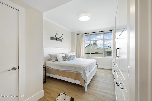 201 N 1st St # 1006, Coeur Dalene, ID 83814 - bedroom featuring crown molding and light wood-style floors