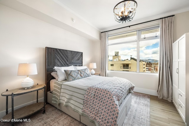 201 N 1st St # 1006, Coeur Dalene, ID 83814 - bedroom featuring a chandelier and wood finished floors