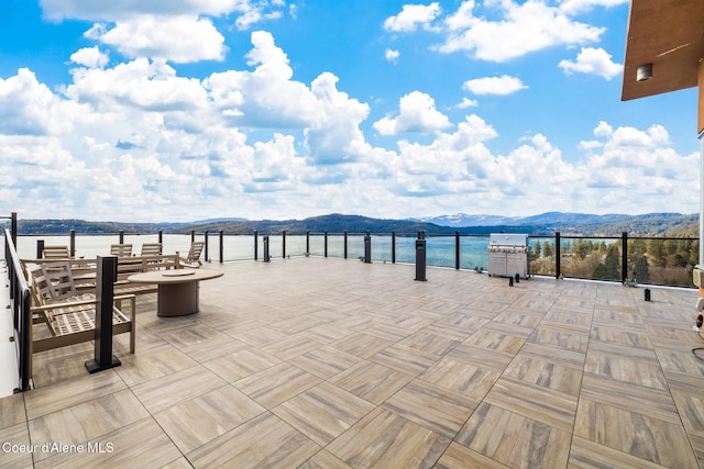 201 N 1st St # 1006, Coeur Dalene, ID 83814 - view of patio / terrace with a mountain view and a grill