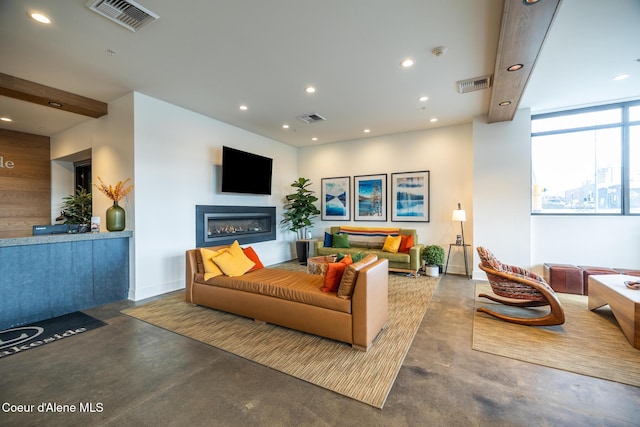 201 N 1st St # 1006, Coeur Dalene, ID 83814 - living room featuring finished concrete floors, recessed lighting, and a glass covered fireplace