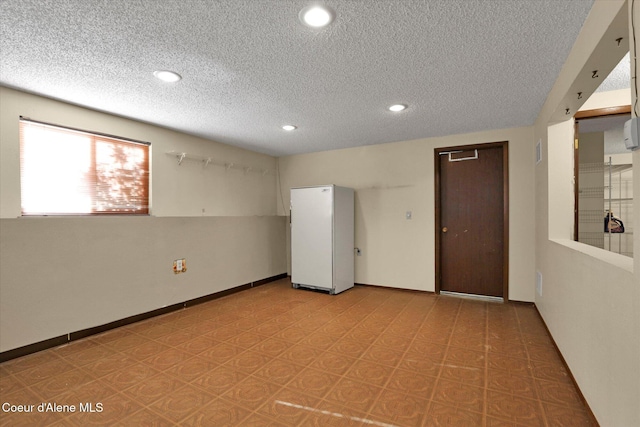 1750 N Havichur Loop, Post Falls, ID 83854 - empty room featuring a textured ceiling, recessed lighting, and light floors