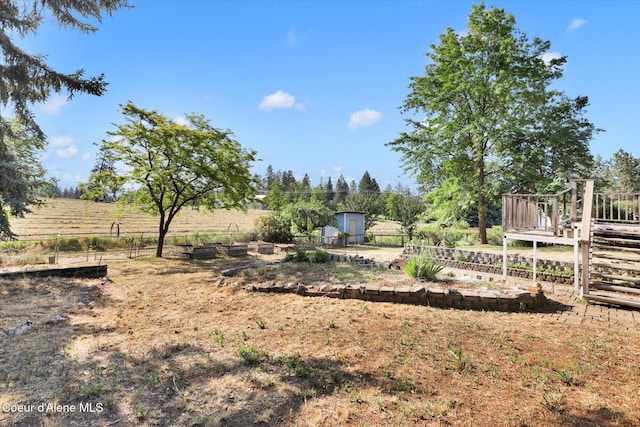 1750 N Havichur Loop, Post Falls, ID 83854 - view of yard with a deck, a storage unit, and a view of countryside