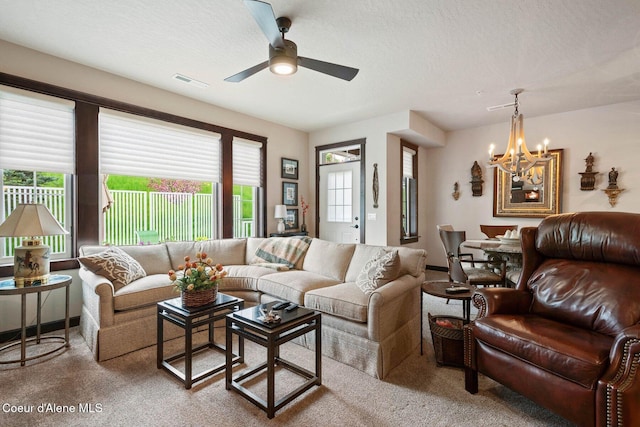 4583 Greenchain Loop Unit 5, Coeur Dalene, ID 83814 - carpeted living room with a chandelier, healthy amount of natural light, ceiling fan, and a textured ceiling