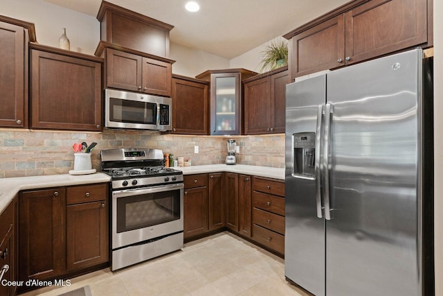 4583 Greenchain Loop Unit 5, Coeur Dalene, ID 83814 - kitchen featuring stainless steel appliances, decorative backsplash, light countertops, and glass insert cabinets