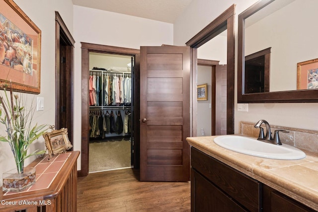 4583 Greenchain Loop Unit 5, Coeur Dalene, ID 83814 - bathroom featuring wood finished floors, vanity, and a spacious closet