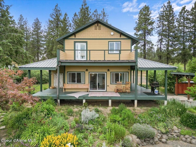 14250 W Sunmeadow Rd, Worley, ID 83876 - back of house with a balcony, a metal roof, and a wooden deck
