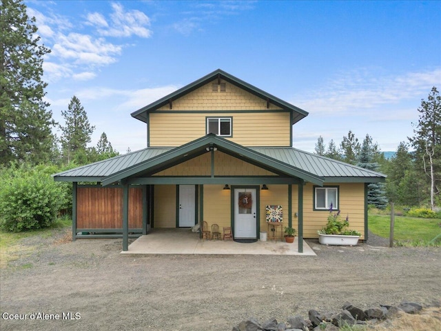14250 W Sunmeadow Rd, Worley, ID 83876 - view of front of house with a metal roof, a porch, and a standing seam roof