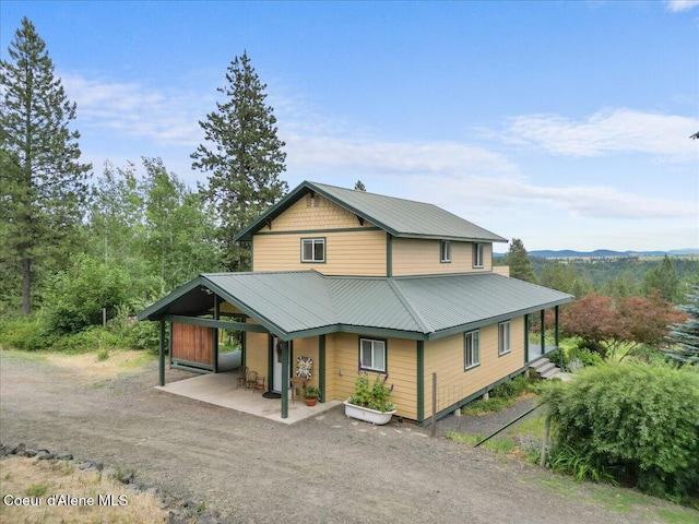 14250 W Sunmeadow Rd, Worley, ID 83876 - view of front of property featuring a metal roof and a patio