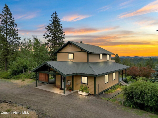 14250 W Sunmeadow Rd, Worley, ID 83876 - view of front of house featuring a metal roof and a patio