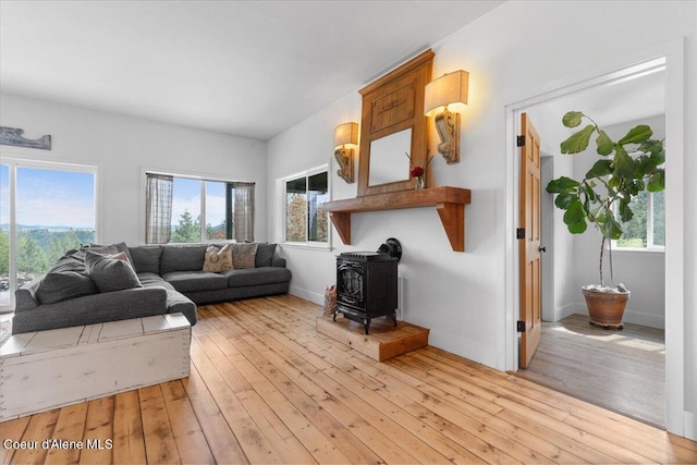 14250 W Sunmeadow Rd, Worley, ID 83876 - living area featuring a wood stove and light wood finished floors