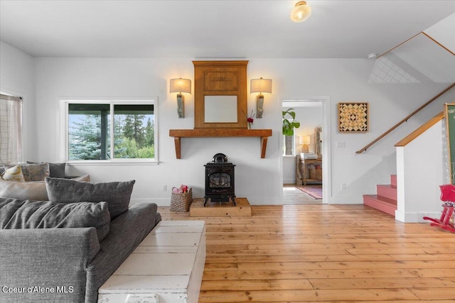 14250 W Sunmeadow Rd, Worley, ID 83876 - living room with stairway, hardwood / wood-style flooring, and a wood stove