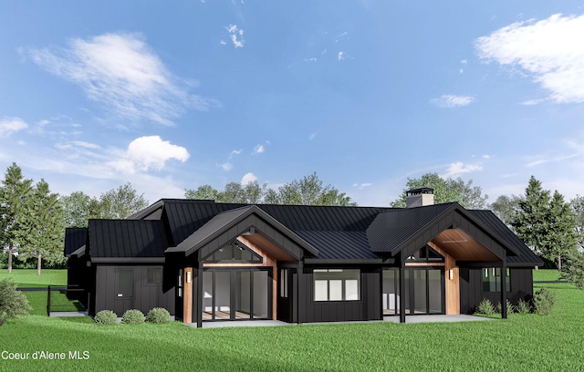 LOT3 Werre Rd, Rathdrum, ID 83858 - rear view of property featuring board and batten siding, a standing seam roof, a lawn, and a chimney