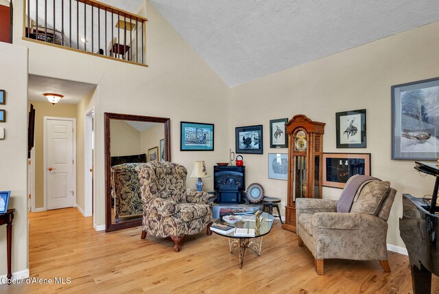 1600 Shepherd Rd, Saint Maries, ID 83861 - living room with wood finished floors, high vaulted ceiling, and a wood stove