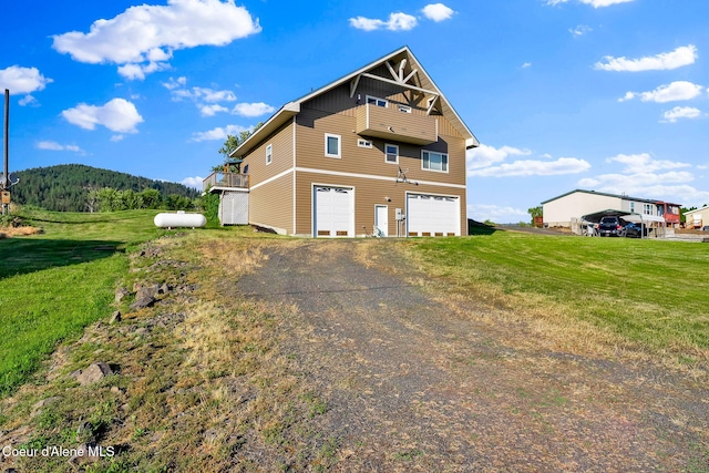 1600 Shepherd Rd, Saint Maries, ID 83861 - view of property exterior with driveway, a garage, a lawn, and a balcony