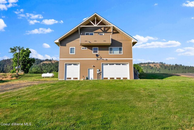 1600 Shepherd Rd, Saint Maries, ID 83861 - rear view of property featuring driveway, a lawn, and board and batten siding