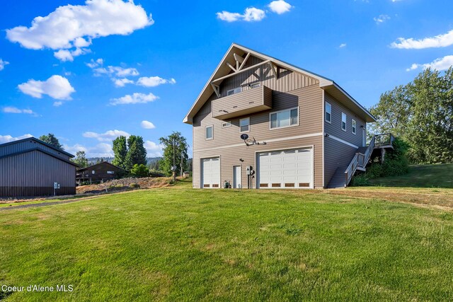 1600 Shepherd Rd, Saint Maries, ID 83861 - rear view of property featuring a garage, board and batten siding, driveway, and a yard