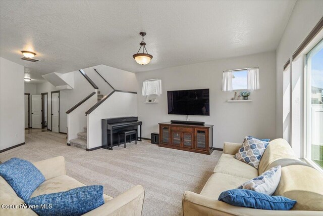 1824 E Warbler Ln, Post Falls, ID 83854 - living area featuring carpet, stairway, and a textured ceiling