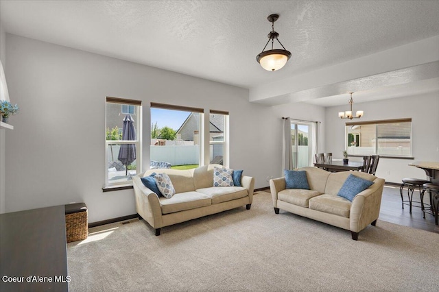 1824 E Warbler Ln, Post Falls, ID 83854 - living area with a chandelier, carpet, and a textured ceiling