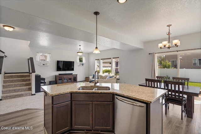 1824 E Warbler Ln, Post Falls, ID 83854 - kitchen featuring stainless steel dishwasher, open floor plan, wood finished floors, a chandelier, and a textured ceiling