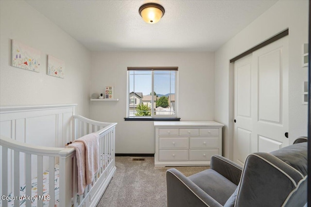 1824 E Warbler Ln, Post Falls, ID 83854 - bedroom featuring light carpet, a closet, and a crib