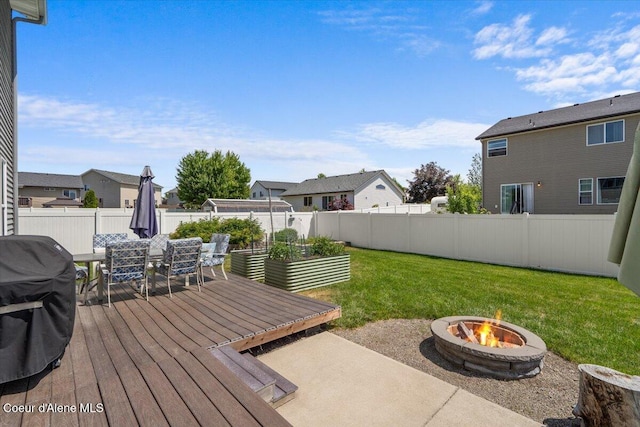 1824 E Warbler Ln, Post Falls, ID 83854 - wooden deck featuring an outdoor fire pit, a residential view, area for grilling, and a fenced backyard