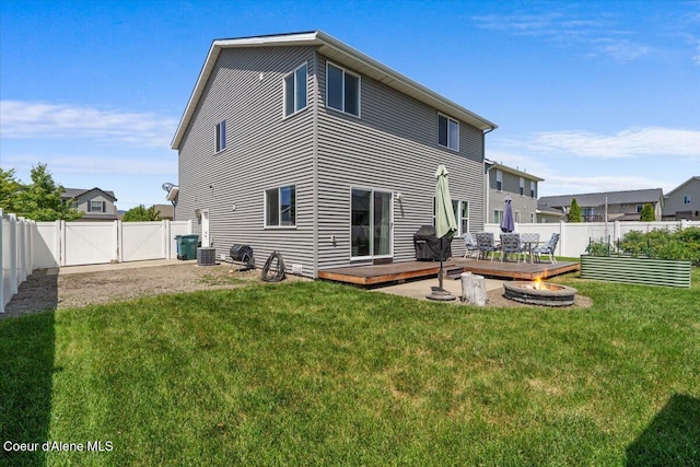 1824 E Warbler Ln, Post Falls, ID 83854 - back of house featuring a deck, a gate, a fenced backyard, and an outdoor fire pit