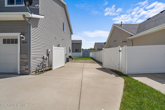 1824 E Warbler Ln, Post Falls, ID 83854 - view of side of property featuring a gate and a garage