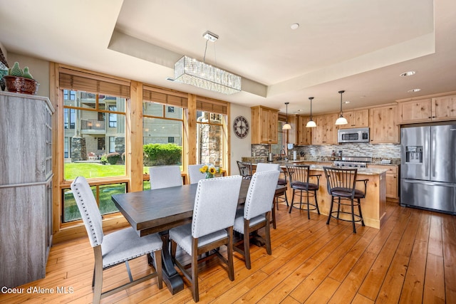 653 Dover Bay Pkwy Unit 101, Dover, ID 83825 - dining room featuring a tray ceiling, light wood finished floors, and recessed lighting