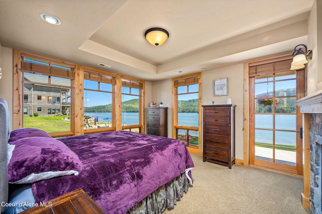 653 Dover Bay Pkwy Unit 101, Dover, ID 83825 - carpeted bedroom featuring a water view, a fireplace, access to outside, multiple windows, and recessed lighting