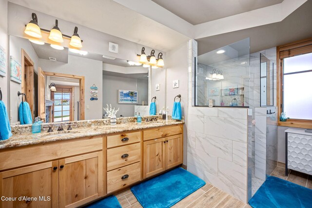 653 Dover Bay Pkwy Unit 101, Dover, ID 83825 - full bath with walk in shower, double vanity, and wood finished floors