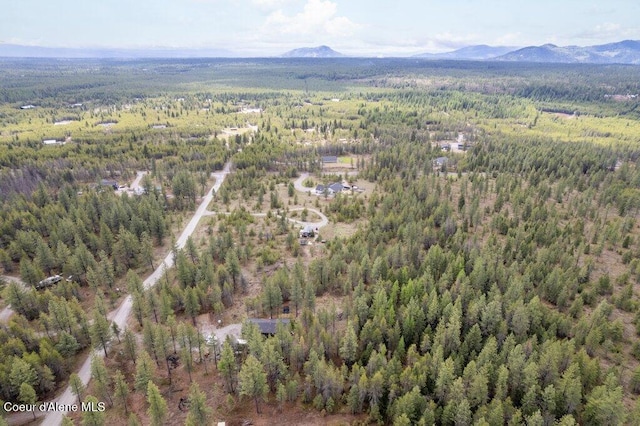 172 Wyatt Ln, Spirit Lake, ID 83869 - aerial view of property and surrounding area featuring a forest and a mountainous background