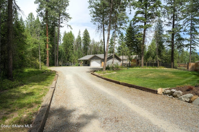 81 Mango St, Moyie Springs, ID 83845 - view of front of property featuring driveway, an attached garage, and a view of trees