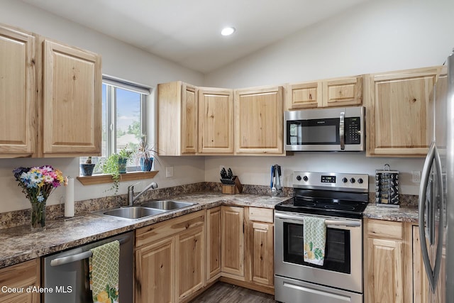 81 Mango St, Moyie Springs, ID 83845 - kitchen featuring appliances with stainless steel finishes, light brown cabinetry, vaulted ceiling, wood finished floors, and recessed lighting