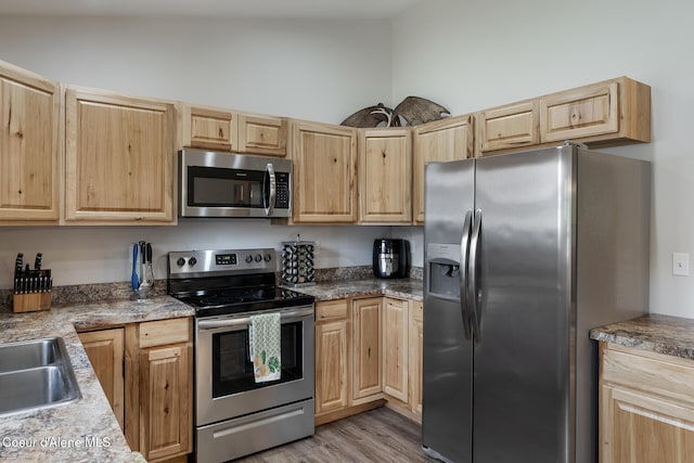 81 Mango St, Moyie Springs, ID 83845 - kitchen featuring appliances with stainless steel finishes, light brown cabinetry, and light wood-type flooring