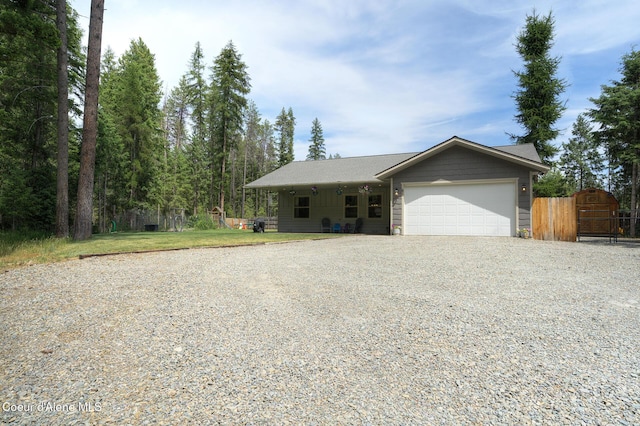 81 Mango St, Moyie Springs, ID 83845 - view of front facade with gravel driveway, an attached garage, and a gate