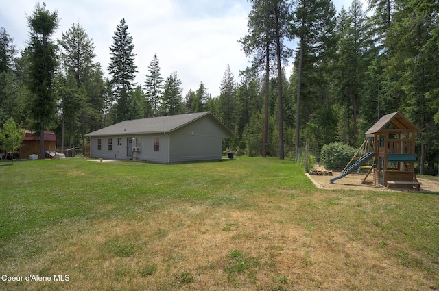 81 Mango St, Moyie Springs, ID 83845 - view of green lawn featuring a playground and a view of trees