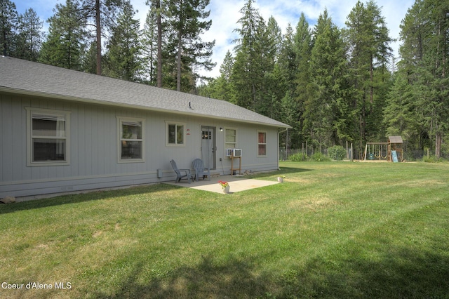 81 Mango St, Moyie Springs, ID 83845 - rear view of property featuring a playground, a patio, a lawn, and a shingled roof
