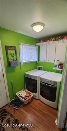 817 6th St, Kamiah, ID 83536 - washroom with cabinet space, washing machine and clothes dryer, and wood finished floors