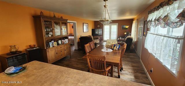 817 6th St, Kamiah, ID 83536 - dining space with dark wood finished floors and baseboards
