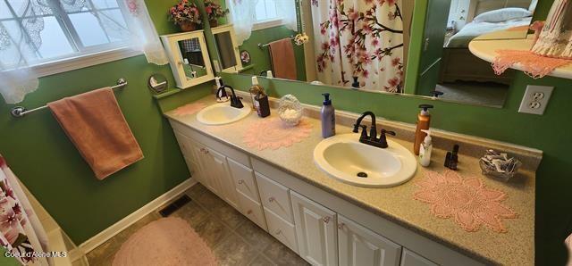 817 6th St, Kamiah, ID 83536 - full bath with double vanity and tile patterned floors
