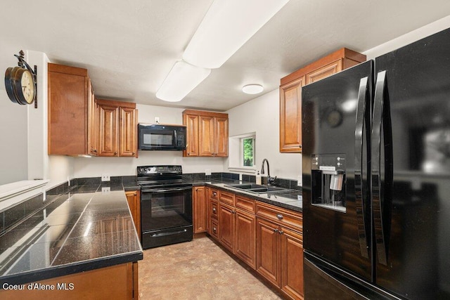 116 Mathews Ridge Rd, Priest River, ID 83856 - kitchen with black appliances, tile countertops, and brown cabinets
