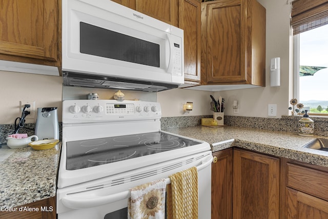 635 N Divot Ave, Post Falls, ID 83854 - kitchen featuring white appliances and brown cabinets