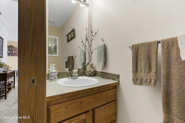 635 N Divot Ave, Post Falls, ID 83854 - bathroom featuring vanity and decorative backsplash