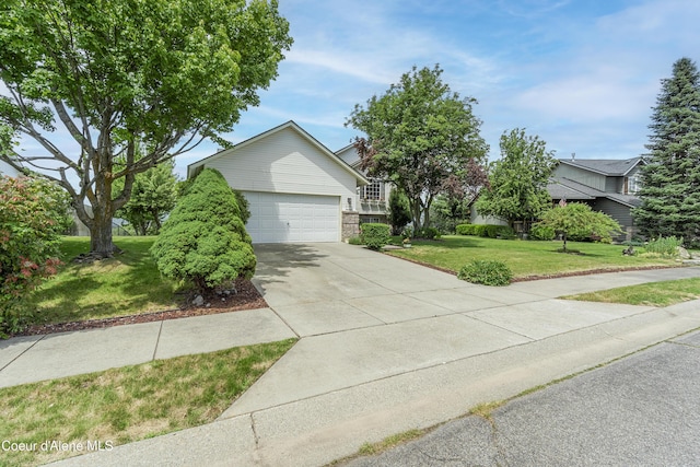 635 N Divot Ave, Post Falls, ID 83854 - obstructed view of property featuring a front lawn, driveway, an attached garage, and brick siding