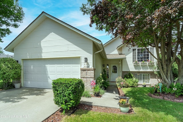 635 N Divot Ave, Post Falls, ID 83854 - view of front facade with an attached garage, driveway, a front yard, and brick siding